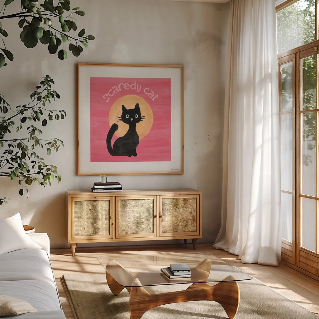 Scaredy Cat Pink by Beth Grove. Shown in a natural wood frame in a cozy modern living room. Available as an archival giclee rolled canvas, fine art paper, or poster print. SKU 95255a.