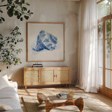 Seaside X Blue by Beth Grove. Shown in a natural wood frame in a cozy modern living room. Available as an archival giclee rolled canvas, fine art paper, or poster print. SKU 80478a.