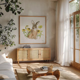 Wildflower Bunnies III Sq by Beth Grove. Shown in a natural wood frame in a cozy modern living room. Available as an archival giclee rolled canvas, fine art paper, or poster print. SKU 24701a.