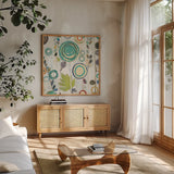 Ocean Garden I Square I by Candra Boggs. Shown in a natural wood frame in a cozy modern living room. Available as an archival giclee rolled canvas, fine art paper, or poster print. SKU 32167a.