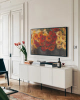 Chelsea Gerberas Grey by Carol Rowan. shown as a framed stretched canvas in a living room above a console. Available as a archival giclee rolled canvas, fine art paper, or poster print. SKU 41566i.