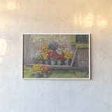 Garden Wheelbarrow by Carol Rowan. shown as a paper print in a white frame. Available as a archival giclee rolled canvas, fine art paper, or poster print. SKU 41551i.
