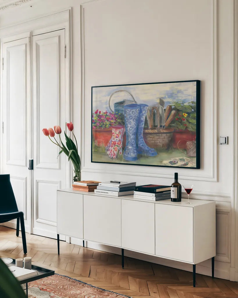 Gardeners Still Life with Boots by Carol Rowan. shown as a framed stretched canvas in a living room above a console. Available as a archival giclee rolled canvas, fine art paper, or poster print. SKU 27739i.