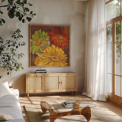 Gerbera Glow I Spice by Carol Rowan. Shown in a natural wood frame in a cozy modern living room. Available as an archival giclee rolled canvas, fine art paper, or poster print. SKU 41934a.