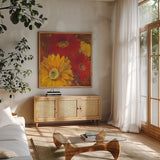 Gerbera Glow II Spice by Carol Rowan. Shown in a natural wood frame in a cozy modern living room. Available as an archival giclee rolled canvas, fine art paper, or poster print. SKU 41937a.