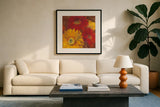 Gerbera Glow II Spice by Carol Rowan. Displayed in a glass frame with matte in a clean modern living room. Available as an archival giclee rolled canvas, fine art paper, or poster print. SKU 41937a.