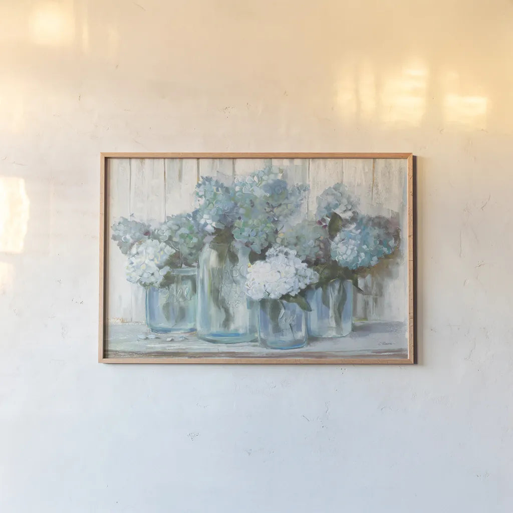 Hydrangeas in Glass Jars Blue Crop by Carol Rowan. shown as a paper print in a natural frame. Available as a archival giclee rolled canvas, fine art paper, or poster print. SKU 46617i.
