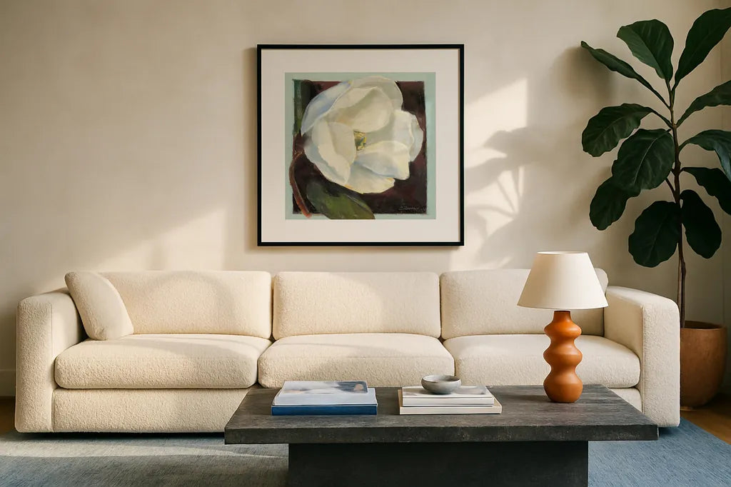 Magnolia I by Carol Rowan. Displayed in a glass frame with matte in a clean modern living room. Available as an archival giclee rolled canvas, fine art paper, or poster print. SKU 7859a.