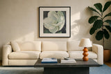 Magnolia III Sage by Carol Rowan. Displayed in a glass frame with matte in a clean modern living room. Available as an archival giclee rolled canvas, fine art paper, or poster print. SKU 47396a.