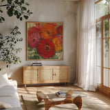 Summer Gerberas I by Carol Rowan. Shown in a natural wood frame in a cozy modern living room. Available as an archival giclee rolled canvas, fine art paper, or poster print. SKU 27831a.