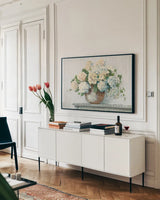 White Hydrangea Cottage by Carol Rowan. shown as a framed stretched canvas in a living room above a console. Available as a archival giclee rolled canvas, fine art paper, or poster print. SKU 51425i.