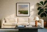 Brilliant Marsh Sunset by Carson Overstreet. Displayed in a glass frame with matte in a clean modern living room. Available as an archival giclee rolled canvas, fine art paper, or poster print. SKU 99714a.