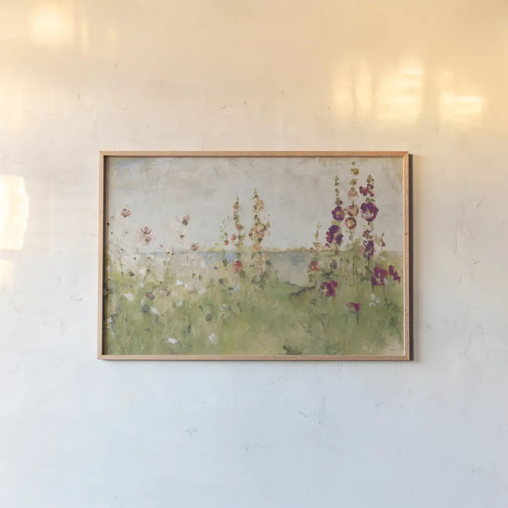 Hollyhocks by the Sea by Cheri Blum. shown as a paper print in a natural frame. Available as a archival giclee rolled canvas, fine art paper, or poster print. SKU 8256i.