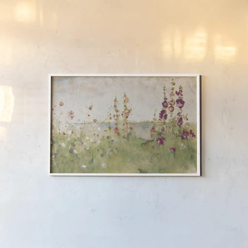 Hollyhocks by the Sea by Cheri Blum. shown as a paper print in a white frame. Available as a archival giclee rolled canvas, fine art paper, or poster print. SKU 8256i.