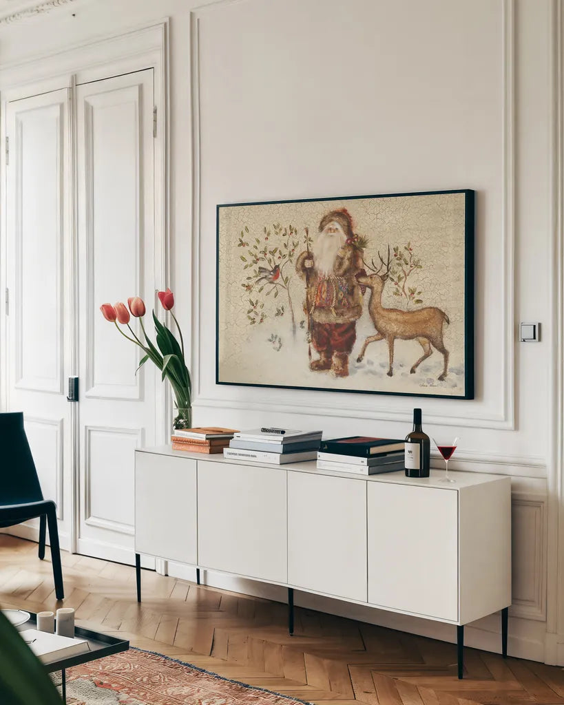 Santa with Deer by Cheri Blum. shown as a framed stretched canvas in a living room above a console. Available as a archival giclee rolled canvas, fine art paper, or poster print. SKU 90376i.