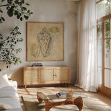Shells IV by Cheri Blum. Shown in a natural wood frame in a cozy modern living room. Available as an archival giclee rolled canvas, fine art paper, or poster print. SKU 7251a.