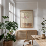 Trunk with Palm Frond by Cheri Blum. shown as a print in a natural wood frame in a dining room. Available as a archival giclee rolled canvas, fine art paper, or poster print. SKU 7185h.