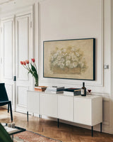 White Floral Bouquet I by Cheri Blum. shown as a framed stretched canvas in a living room above a console. Available as a archival giclee rolled canvas, fine art paper, or poster print. SKU 6885i.