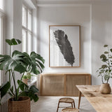 Black Feather V by Chris Paschke. shown as a print in a natural wood frame in a dining room. Available as a archival giclee rolled canvas, fine art paper, or poster print. SKU 28001h.