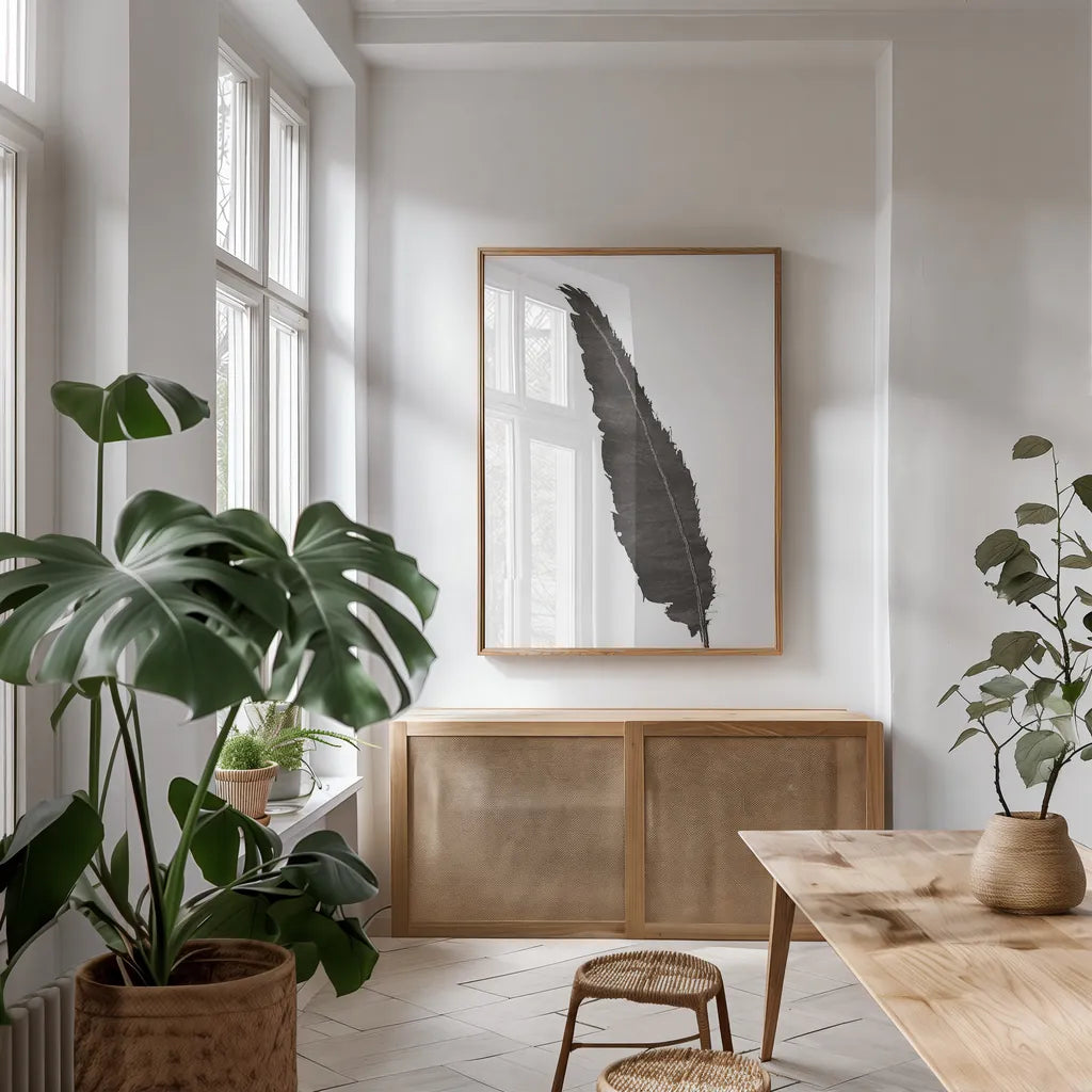 Black Feather VI by Chris Paschke. shown as a print in a natural wood frame in a dining room. Available as a archival giclee rolled canvas, fine art paper, or poster print. SKU 28002h.