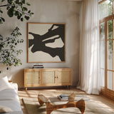 Black Gesture II by Chris Paschke. Shown in a natural wood frame in a cozy modern living room. Available as an archival giclee rolled canvas, fine art paper, or poster print. SKU 69345a.
