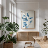 Blue Branch I by Chris Paschke. shown as a print in a natural wood frame in a dining room. Available as a archival giclee rolled canvas, fine art paper, or poster print. SKU 55059h.