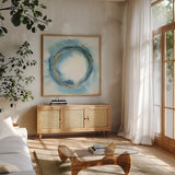 Buddha Enso by Chris Paschke. Shown in a natural wood frame in a cozy modern living room. Available as an archival giclee rolled canvas, fine art paper, or poster print. SKU 48029a.