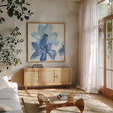 Cobalt Clematis I by Chris Paschke. Shown in a natural wood frame in a cozy modern living room. Available as an archival giclee rolled canvas, fine art paper, or poster print. SKU 33996a.