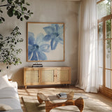 Cobalt Clematis II by Chris Paschke. Shown in a natural wood frame in a cozy modern living room. Available as an archival giclee rolled canvas, fine art paper, or poster print. SKU 33997a.