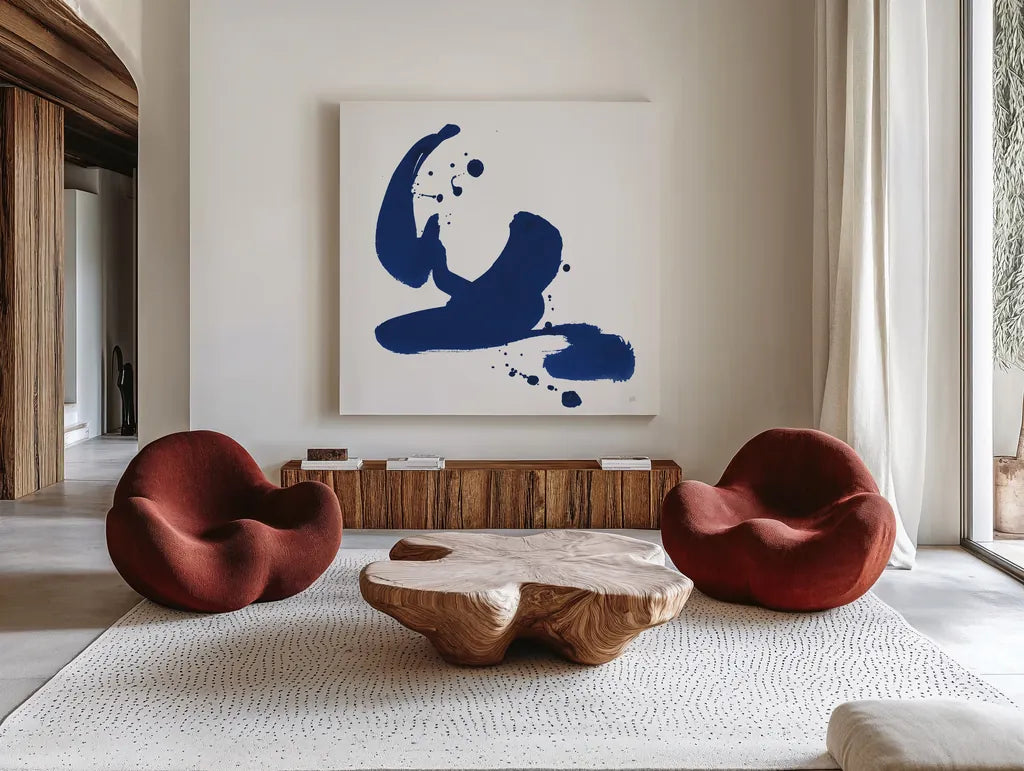 Cobalt Ink Drops I by Chris Paschke. Shown as extra-large giant wall art in a modern living room. Available as an archival giclee rolled canvas, fine art paper, or poster print. SKU 67368a.