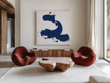 Cobalt Ink Drops II by Chris Paschke. Shown as extra-large giant wall art in a modern living room. Available as an archival giclee rolled canvas, fine art paper, or poster print. SKU 67369a.