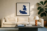 Cobalt Ink Drops III by Chris Paschke. Displayed in a glass frame with matte in a clean modern living room. Available as an archival giclee rolled canvas, fine art paper, or poster print. SKU 67370a.