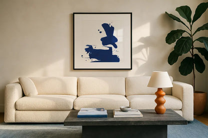 Cobalt Ink Drops III by Chris Paschke. Displayed in a glass frame with matte in a clean modern living room. Available as an archival giclee rolled canvas, fine art paper, or poster print. SKU 67370a.