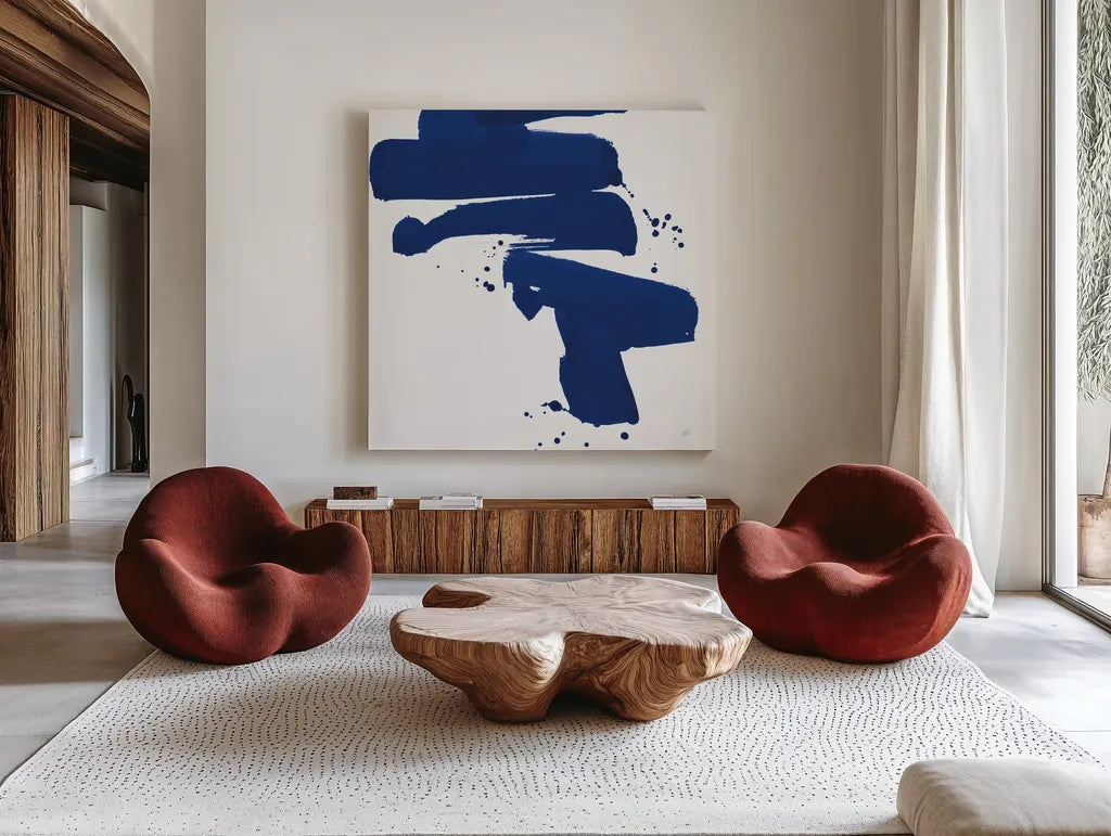 Cobalt Ink Drops IV by Chris Paschke. Shown as extra-large giant wall art in a modern living room. Available as an archival giclee rolled canvas, fine art paper, or poster print. SKU 67371a.