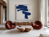 Cobalt Ink Drops IV by Chris Paschke. Shown as extra-large giant wall art in a modern living room. Available as an archival giclee rolled canvas, fine art paper, or poster print. SKU 67371a.