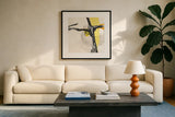 Creamy Yellow II by Chris Paschke. Displayed in a glass frame with matte in a clean modern living room. Available as an archival giclee rolled canvas, fine art paper, or poster print. SKU 26813a.