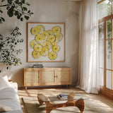 Cut Lemons III by Chris Paschke. Shown in a natural wood frame in a cozy modern living room. Available as an archival giclee rolled canvas, fine art paper, or poster print. SKU 66886a.