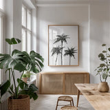 Dark Palms I by Chris Paschke. shown as a print in a natural wood frame in a dining room. Available as a archival giclee rolled canvas, fine art paper, or poster print. SKU 78874h.