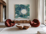 Dharma Wheel I by Chris Paschke. Shown as extra-large giant wall art in a modern living room. Available as an archival giclee rolled canvas, fine art paper, or poster print. SKU 48026a.