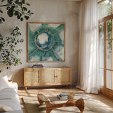 Dharma Wheel II by Chris Paschke. Shown in a natural wood frame in a cozy modern living room. Available as an archival giclee rolled canvas, fine art paper, or poster print. SKU 48027a.
