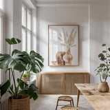 Earthy Vase Gray Bunny Tail by Chris Paschke. shown as a print in a natural wood frame in a dining room. Available as a archival giclee rolled canvas, fine art paper, or poster print. SKU 77173h.