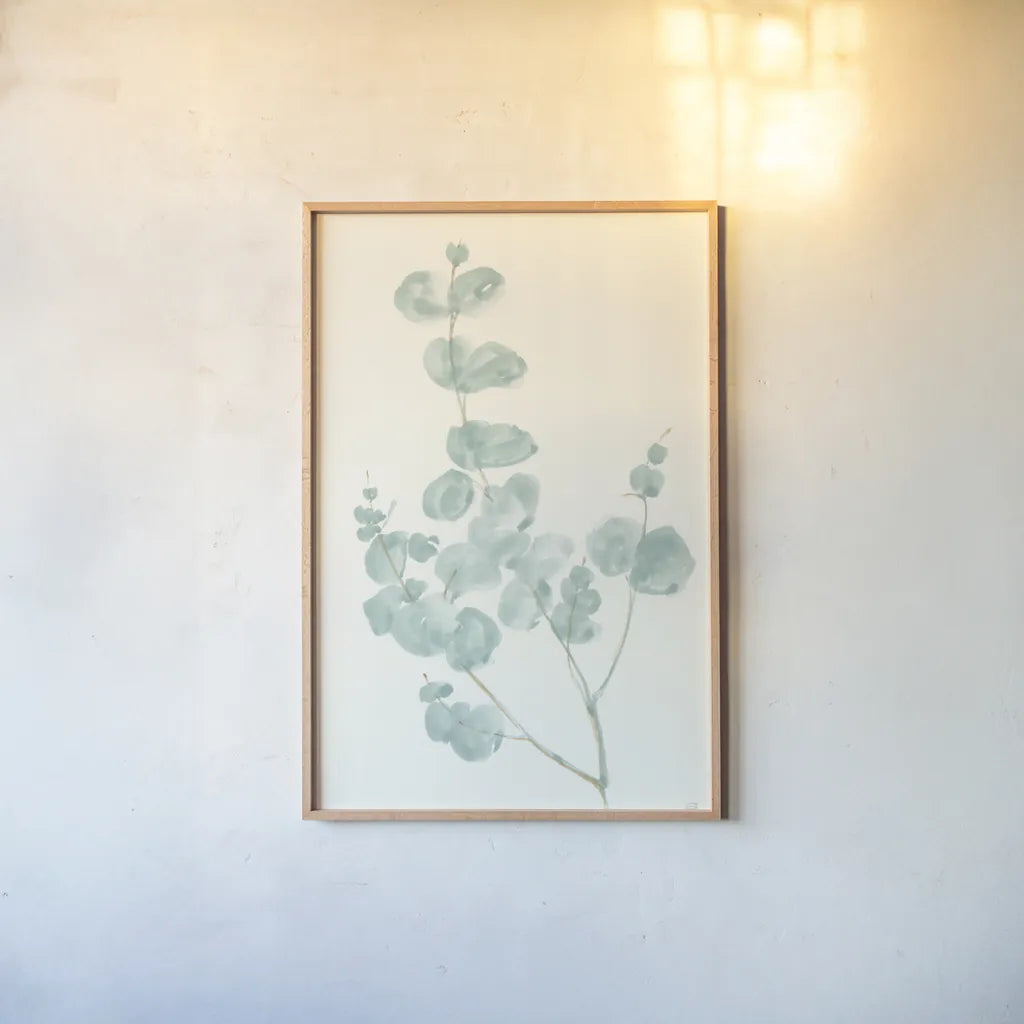 Eucalyptus Branch I by Chris Paschke. shown as a paper print in a natural frame. Available as a archival giclee rolled canvas, fine art paper, or poster print. SKU 55063h.