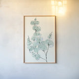 Eucalyptus Branch III by Chris Paschke. shown as a paper print in a natural frame. Available as a archival giclee rolled canvas, fine art paper, or poster print. SKU 55065h.