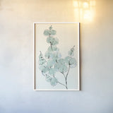Eucalyptus Branch III by Chris Paschke. shown as a paper print in a white frame. Available as a archival giclee rolled canvas, fine art paper, or poster print. SKU 55065h.