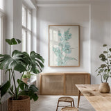 Eucalyptus Branch IV by Chris Paschke. shown as a print in a natural wood frame in a dining room. Available as a archival giclee rolled canvas, fine art paper, or poster print. SKU 55066h.