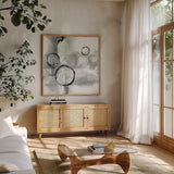 Full Circle I Gray by Chris Paschke. Shown in a natural wood frame in a cozy modern living room. Available as an archival giclee rolled canvas, fine art paper, or poster print. SKU 22778a.