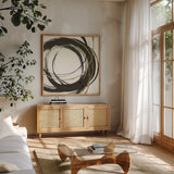 Gilded Enso II by Chris Paschke. Shown in a natural wood frame in a cozy modern living room. Available as an archival giclee rolled canvas, fine art paper, or poster print. SKU 34702a.