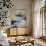 Gilded Indigo I by Chris Paschke. Shown in a natural wood frame in a cozy modern living room. Available as an archival giclee rolled canvas, fine art paper, or poster print. SKU 25553a.