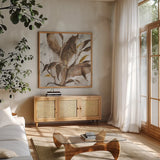 Gilded Leaf Collage v2 I by Chris Paschke. Shown in a natural wood frame in a cozy modern living room. Available as an archival giclee rolled canvas, fine art paper, or poster print. SKU 97047a.