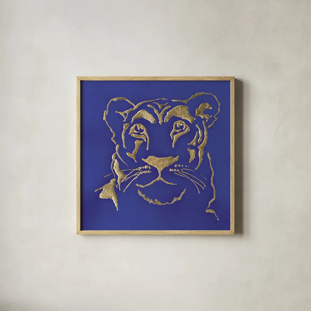 Gilded Lioness Indigo by Chris Paschke. Shown in a natural wood glass frame for a timeless modern aesthetic. Available as an archival giclee rolled canvas, fine art paper, or poster print. SKU 41918a.